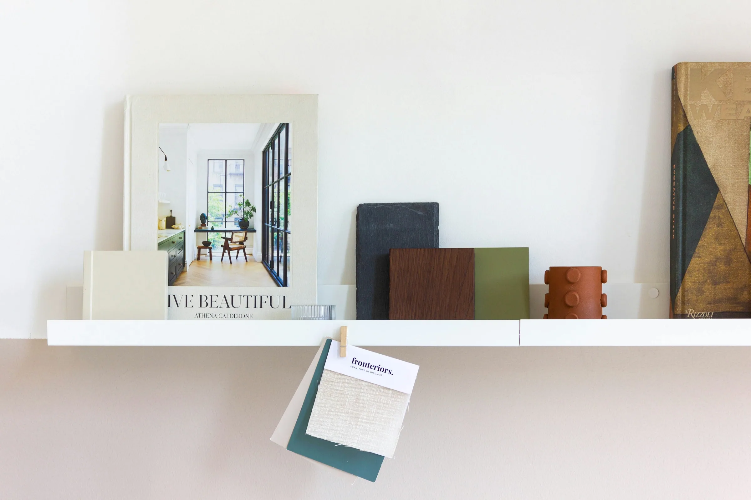 Design books and interior material samples organized for sourcing research